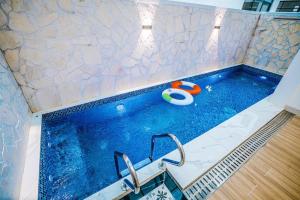 a swimming pool with a ball and a toy in it at Samson Soleil Hotel in Sầm Sơn