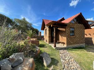 a small brick building with a red roof at La Casa del Abuelito in San Miguel Regla