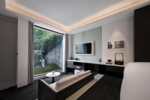 溧阳FU VALLEY Hotel的带沙发和大窗户的客厅