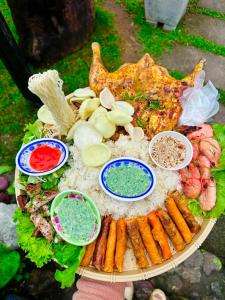 a plate of food with seafood and vegetables on it at Đồi Dẻ Eco HomeStay in Bố Trạch