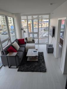 a living room with a couch and a table at Modern 2 bedroom condo with AC in Olympic Village in Vancouver
