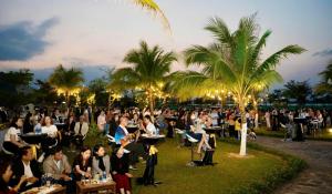 a crowd of people sitting in chairs at a party at Fivitel Nam Hoi An Riverside in Thuận An +68 photos