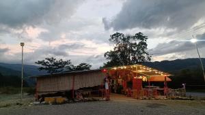 a building with a tent with lights on it at Hotel y Estadero Los Colores in Pajarito