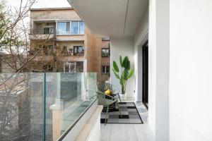 an open balcony with a chair and a building at CHANTTAL Luxury - AMZEI in Bucharest