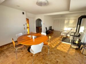 a living room with a wooden table and chairs at すぺーす神楽 in Asahikawa