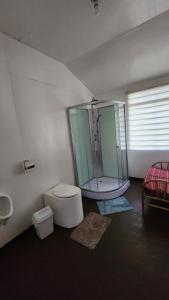 a bathroom with a glass shower and a toilet at Samca Titicaca Lodge Puno Peru in Puno