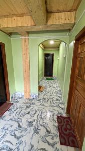 an empty room with a large marble floor at The Good Time homestay in Jālāpahār +5 photos