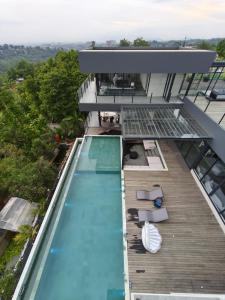 a swimming pool on the roof of a house at Amulya Luxury Villa, Dago - 4BR Heated Infinity Pool in Bandung