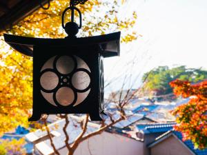 a lantern hanging from the side of a building at KIYOMORI in Hatsukaichi