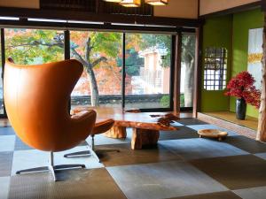 a living room with a chair and a coffee table at KIYOMORI in Hatsukaichi