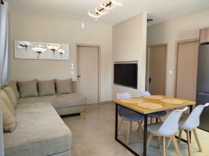 a living room with a table and a couch at SeaEsta Vasiliki 4 in Vasiliki