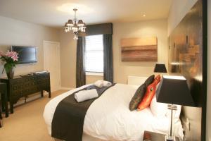 a bedroom with a large bed and a large window at Urban Beach Hotel in Bournemouth