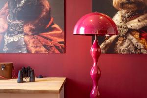 a pink lamp sitting on a desk next to a painting at 3 Windows on St Mark - Waterfront Apartment in Venice +33 photos