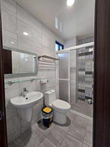 a white bathroom with a toilet and a sink at 綠島209角落Corner of Green Island 台東縣民宿編號第2003號 in Green Island