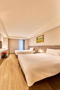 Un pat sau paturi într-o cameră la Hotel Thomas Myeongdong