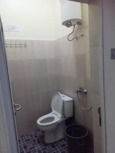 a bathroom with a toilet and a trash can at VILLA Dreams Hillpark Sibolangit Berastagi in Bandarbaru +4 photos