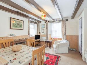 a living room with a table and a dining room at Duck Cottage in Bridlington