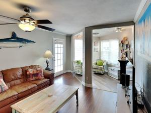 a living room with a couch and a table at Sand In Your Toes in Mustang Beach