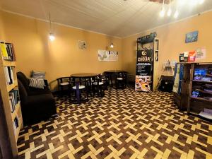 a room with two tables and chairs in a room at Hostal Choja in Quetzaltenango