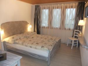 um pequeno quarto com uma cama e uma janela em Hotel Weisshorn em Ritzingen
