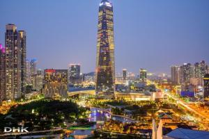 a city skyline at night with a tall building at feel at Home in Incheon +20 photos