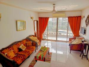 a living room with a couch and a table at Luxury 3 bed apartment in Dhaka