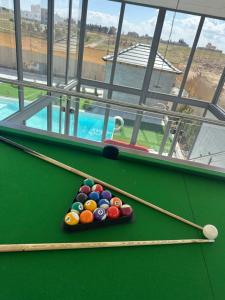 a pool table with balls and paddles on it at the royal occasion amman in Amman