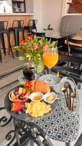a table with a tray of food and drinks on it at Casa Laura Hotel & Suites in Cuenca