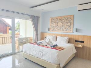a bedroom with a large bed and a balcony at Solaluna Beach Homestay in Amed +37 photos