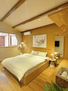 a bedroom with a large bed and a chair at Cherish Villa - Near Mountain and Beach - Sơn Trà in Da Nang