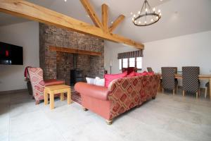 a living room with a couch and a fireplace at Cohost Partners Charming Barn Stay in Llanharan
