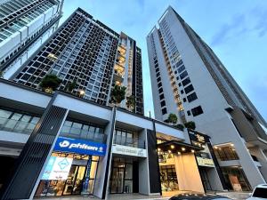 two tall buildings in a city with a store at 1810 SkyTree bukitindah Aeon Legoland 2-3pax in Johor Bahru