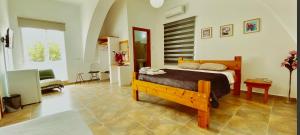 a bedroom with a wooden bed in a room at Hera palace boutique otel in Yialousa