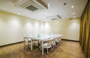 a meeting room with a white table and chairs at Townhouse Bargi Hills Formerly Hotel Sharma in Jabalpur +2 photos