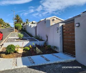 a white house with a fence and a driveway at Modern, Comfy Guest Suite with Beautiful Views in Tygerberg Hills