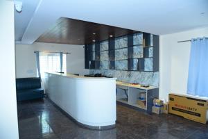 an office with a desk and a counter in a room at Ujwal Comforts in Bangalore