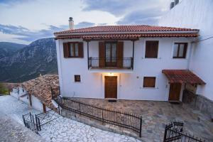 a white house with a balcony and a door at Delphi View - 3 Bedrooms apartment, fully equipped in Delphi