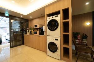 a laundry room with a washer and dryer in a house at Browndot Hwagok in Seoul