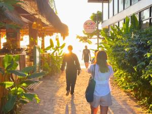 a group of people walking down a street at Suites by Eco Hotels in El Nido