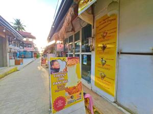 a store with a sign on the side of a street at Suites by Eco Hotels in El Nido