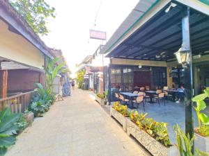an outdoor patio with tables and chairs in a building at Suites by Eco Hotels in El Nido