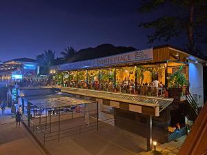 a restaurant with a bar in front of it at night at Suites by Eco Hotels in El Nido