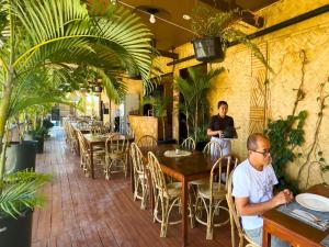 a man sitting at a table in a restaurant at Suites by Eco Hotels in El Nido