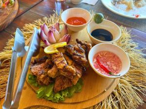 a plate of food with chicken and vegetables on a table at Suites by Eco Hotels in El Nido
