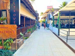 a street with people walking down a sidewalk at Suites by Eco Hotels in El Nido