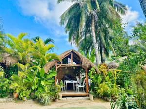 a house on the beach with palm trees at Suites by Eco Hotels in El Nido +37 photos