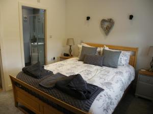 a bedroom with a bed with towels on it at Shay Bank Cottage in Keighley