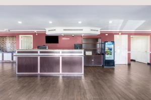 an empty lobby with a cash register and a soda machine at OYO Hotel Tulsa N Sheridan Rd & Airport in Tulsa