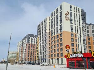 a tall building with a sign in front of it at Soul Park в шаге от Хан шатыр in Astana
