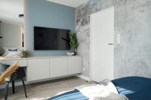 Telewizja i/lub zestaw kina domowego w obiekcie Promenada by Baltic Home